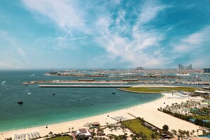 A coastal resort with a beachfront, a marina, and a large hotel complex. - World Class | 1BR | Breathtaking Beach Views (JBR, Dubai)