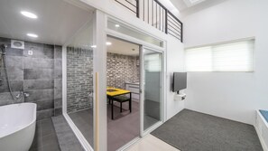 Enjoy a relaxing soak in the bathtub or refreshing shower, then step out onto the balcony with a small table and chairs.