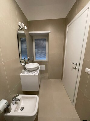 Habitación doble superior, vistas a la ciudad | Baño | Cabezal de ducha tipo lluvia, secador de pelo, bidé y jabón