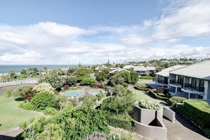 A resort with a pool, landscaped gardens, and a view of the sea. - Pooch Friendly Sunrise Beach 3BR w/ Views (Noosa)