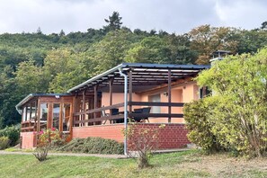 A two-story building with a wooden deck, brick walls, and a metal roof. - Retreat Near Blankenburg Castle (Blankenburg)