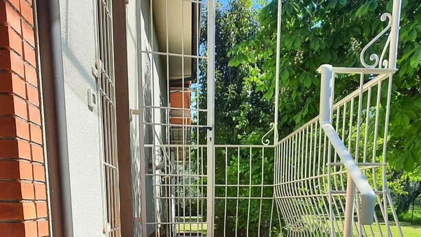 A set of outdoor wooden steps leading to a covered area with a metal railing. - Olive Grove Garden House With Mountain View Close to Forte dei Marmi (Ripa- Pozzi-Ponterosso)