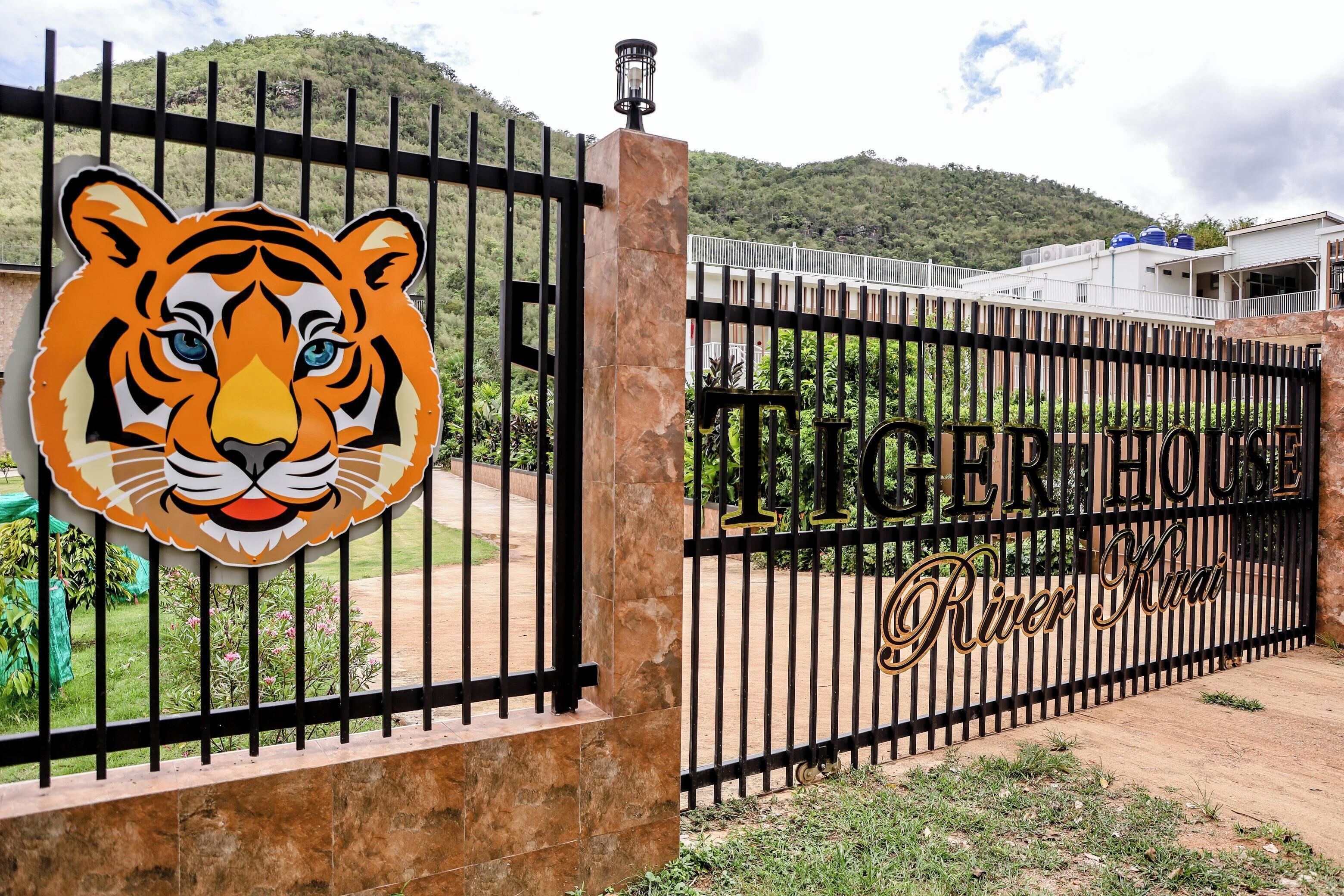 A gated entrance with a tiger logo and the name "Tiger House River Kuai".