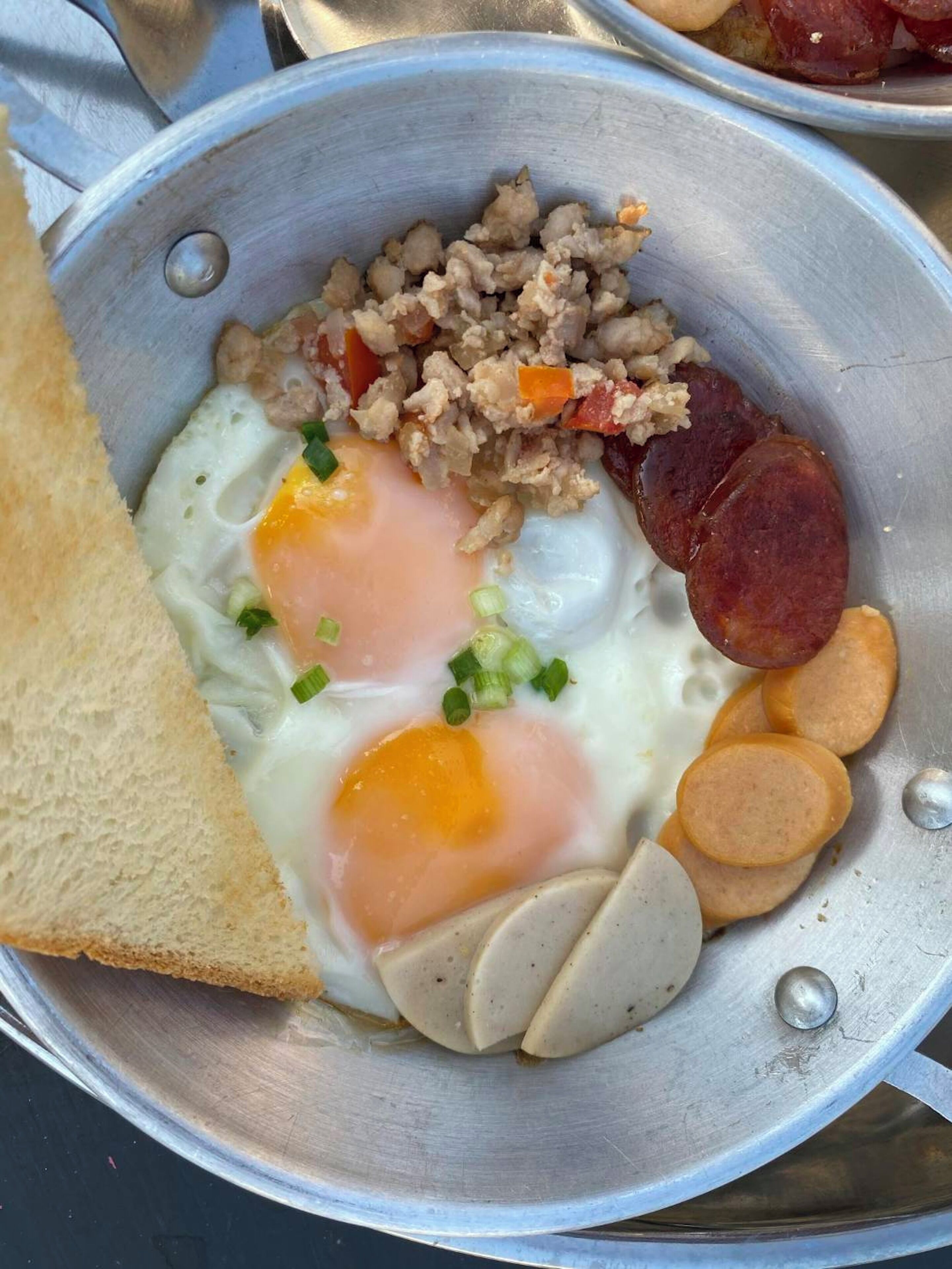 A breakfast plate with eggs, sausage, and toast.