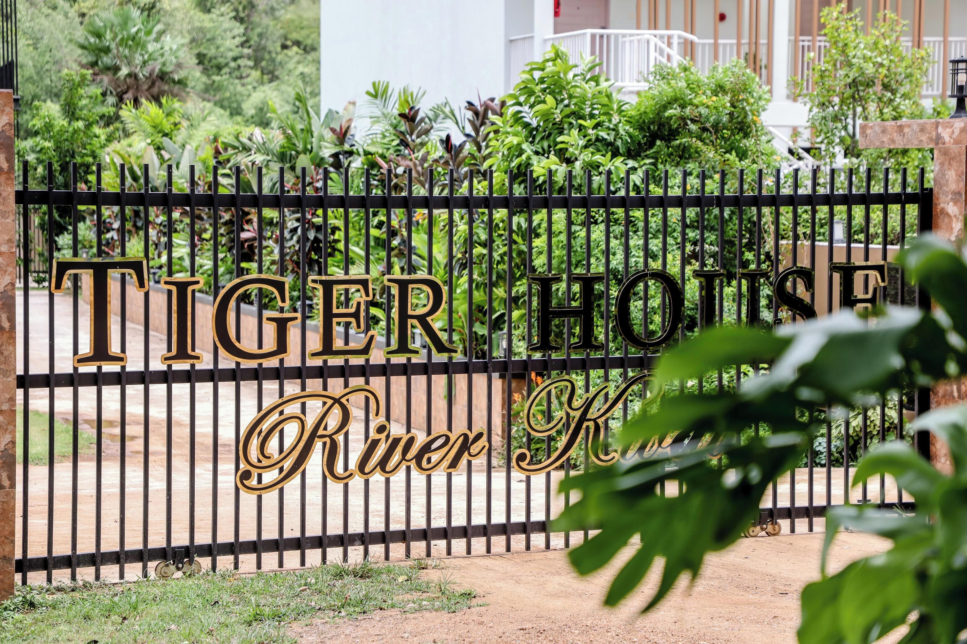 A gated entrance with the sign "Tiger House River K."