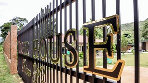 A gated entrance with the words "River House" in large, decorative letters. - Tiger House River Kwai (Si Sawat)