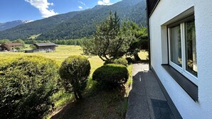 A view from a window overlooking a mountainous landscape with a clear sky. - Cosy Apartment in Gortipohl With Garden (Sankt Gallenkirch)