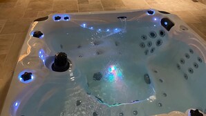 A hot tub with LED lights, a pool, and a sun lounger. - Holiday Home in Sprimont With Forest (Sprimont)