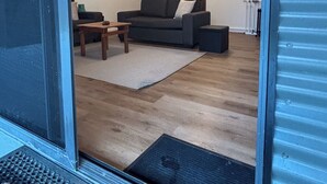 A modern living room with a sofa, coffee table, and rug.