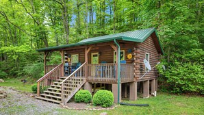 A log cabin with a porch, stairs, and a small deck area. - Creek Front Cabin in Pearisburg (Pearisburg)