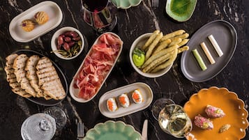 A variety of food items and dishes arranged on a dark marble table.