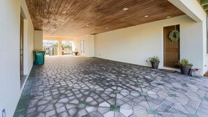 A covered outdoor area with a hexagonal tile floor and a wooden ceiling. - Waterfront Home w/ Pool, Boat Slip & Private Beach Access – Holiday Isle (Destin)