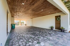 Un'area esterna coperta con pavimento in piastrelle esagonali e soffitto in legno.