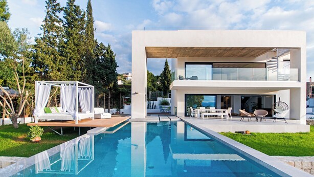 A modern outdoor pool area with a glass-enclosed cabana and outdoor furniture. - Villa O2 - beautiful property in Alcudia (Alcudia)