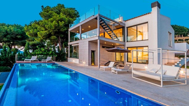 A modern two-story house with a swimming pool, outdoor seating, and a staircase leading to the upper floor. - Villa Panoramica - modern villa in Alcudia (Alcudia)