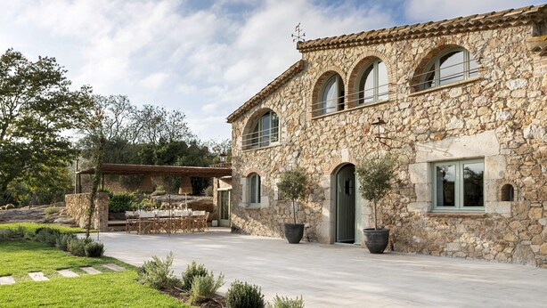 A stone building with arched windows and a covered patio area. - Mas del Suro -  Masia in the heart of Costa Brava (Mont-ras)