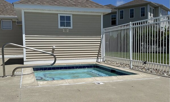 A small outdoor swimming pool with a metal ladder and a white fence. - On The River, Assn Pool & Hot Tub, Water Taxi in Summer (St. Joseph)