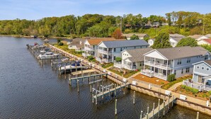 A waterfront residential area with houses connected by docks to a lake. - On The River, Assn Pool & Hot Tub, Water Taxi in Summer (St. Joseph)