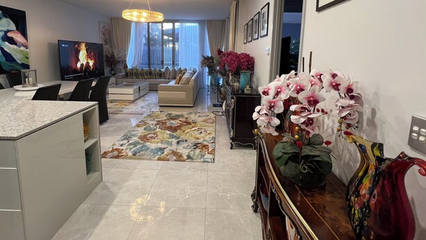 A modern living room with a sofa, TV, and decorative plants. - Centre of town  (Sydney)