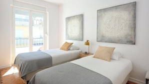 A hotel room with two beds, a balcony, and artwork on the walls. - Enjoy The Sunny Balcony, By Timecooler (Lisbon)
