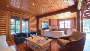 A log cabin interior with a living area, kitchen, and dining space. - Beach & Golf Retreat W Amazing Pool, By Timecooler (Almada)