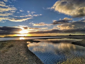 A calm body of water reflecting the sky, with a distant shoreline and a sunset. - 4 Star Holiday Home in Ronde (Ronde)
