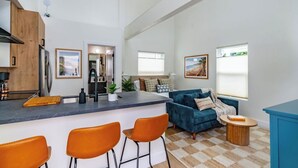 A modern apartment with a kitchen, living area, and dining space. - Swanky Studio in Vibrant Hillcrest (San Diego)