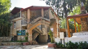 A stone building with a balcony and a staircase leading to the upper floor. - Ballı Boutique Hotel & Restaurant  (Fethiye)