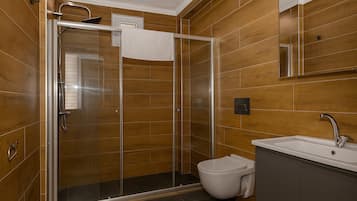 Deluxe Quadruple Room, Multiple Beds | Bathroom | Shower, hair dryer, towels, soap