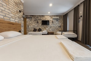 Deluxe Quadruple Room, Multiple Beds | 1 bedroom, minibar, laptop workspace, bed sheets