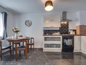 Enjoy cooking in this well-equipped kitchen with a central island, oven, and range hood.