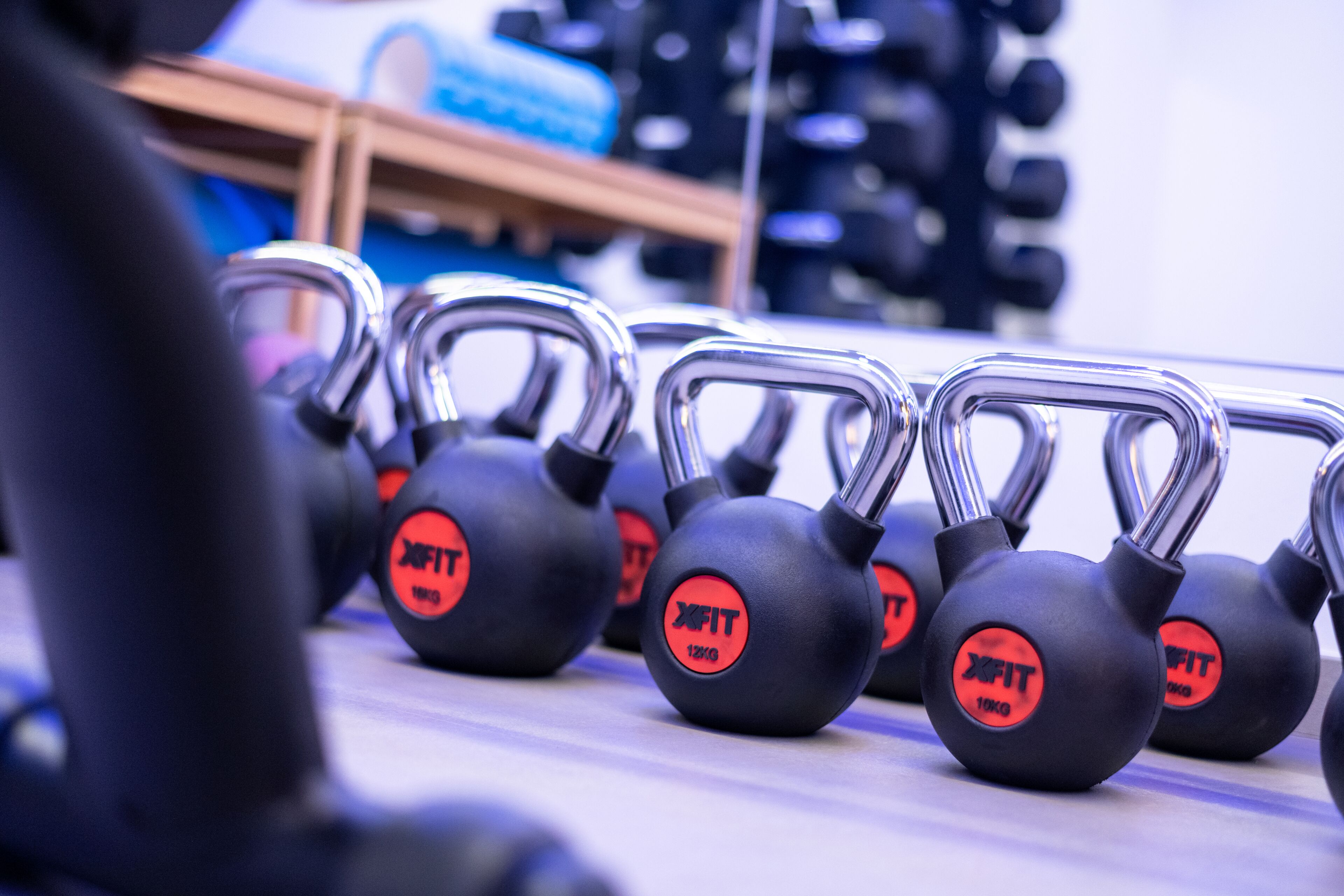 A row of kettlebells with the brand "XFIT" and weight markings.