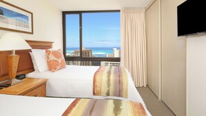 A hotel room with a large window offering a view of the ocean and cityscape. - Ocean & Diamond Head Views! Full Kitchen, Lanai, FREE Parking, Wi-Fi & TV! (Honolulu)
