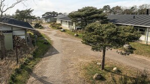 A gravel path leading to a row of cabins with a clear sky above. - 6 Person Holiday Park Home in Gilleleje (Gilleleje)