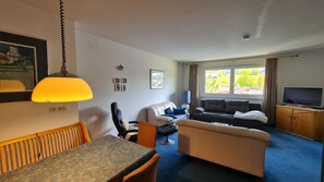 Enjoy a comfortable stay in this well-appointed room with a dining area, sofa, flat-screen TV, and large window offering a view of the outdoors.