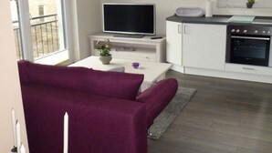 A modern living room with a purple sofa, a flat-screen TV, a kitchen with a stove and oven, and a balcony with a railing.