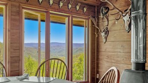 A wooden cabin with large windows offering a mountain view. - GrandView @ Smoky Ridge: Stunning Mtn Views, Large Deck & Windows | Pet Friendly (Cullowhee)