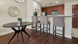 Cocina moderna con armarios de madera, microondas y refrigerador.