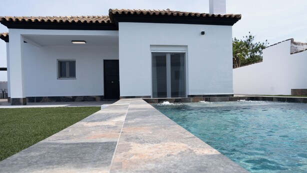 A modern house with a swimming pool, a tiled deck, and a well-maintained lawn. - Domus Gades        . (Chiclana)