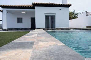A modern house with a swimming pool, a tiled deck, and a well-maintained lawn. - Domus Gades        . (Chiclana)