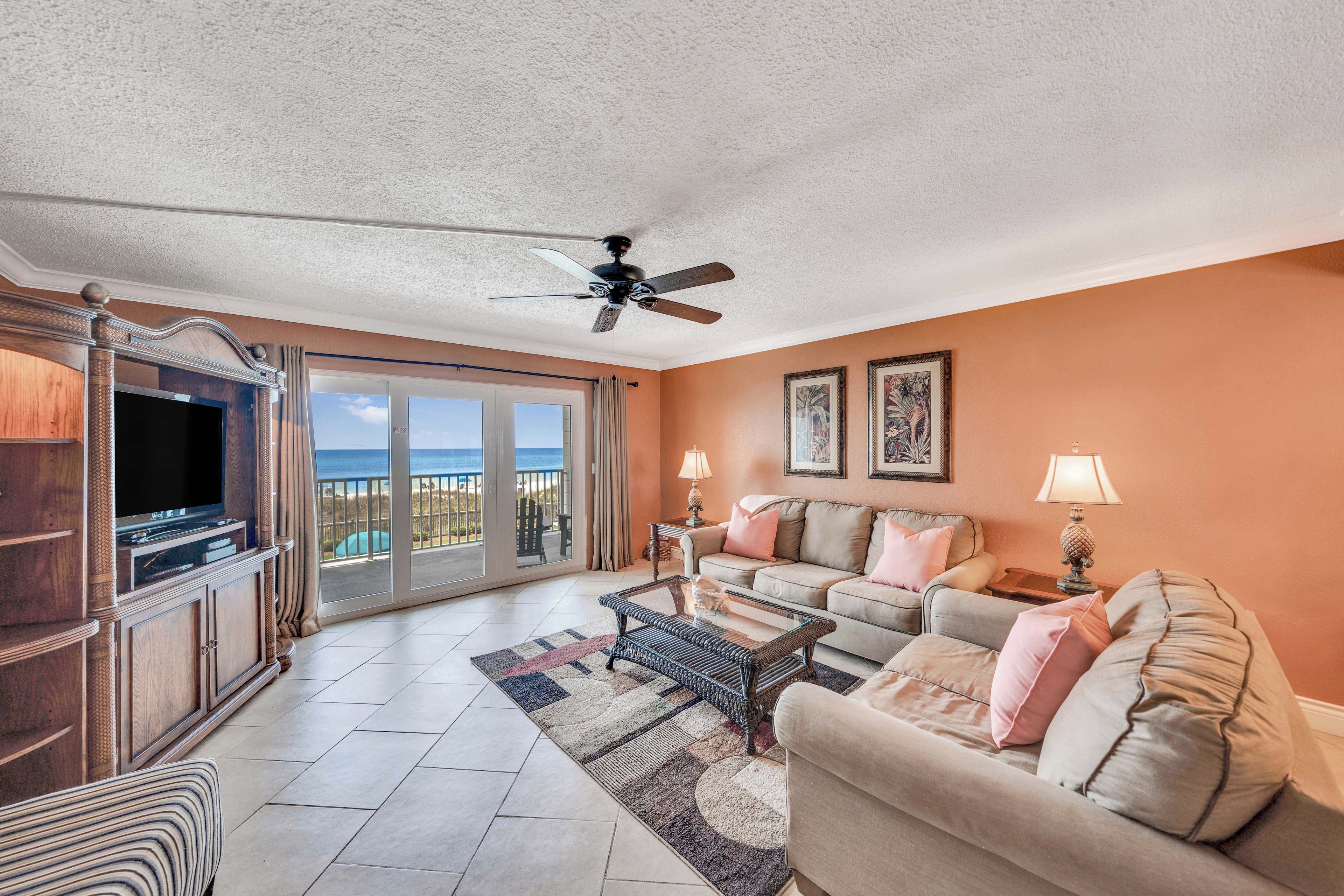 A spacious living room with a television, sofa, and coffee table.
