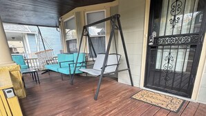 A wooden deck with a swing set, turquoise chairs, and a black gate. - Home away from home, 
 By university , hospitals ,  museum,
Pet friendly. (Cleveland)