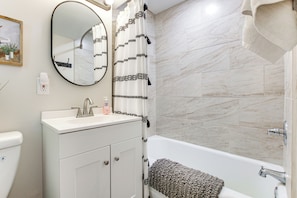 A bathroom with a white sink, mirror, and bathtub. - Charming Appleton Getaway ~ 3 Mi to Downtown! (Appleton)