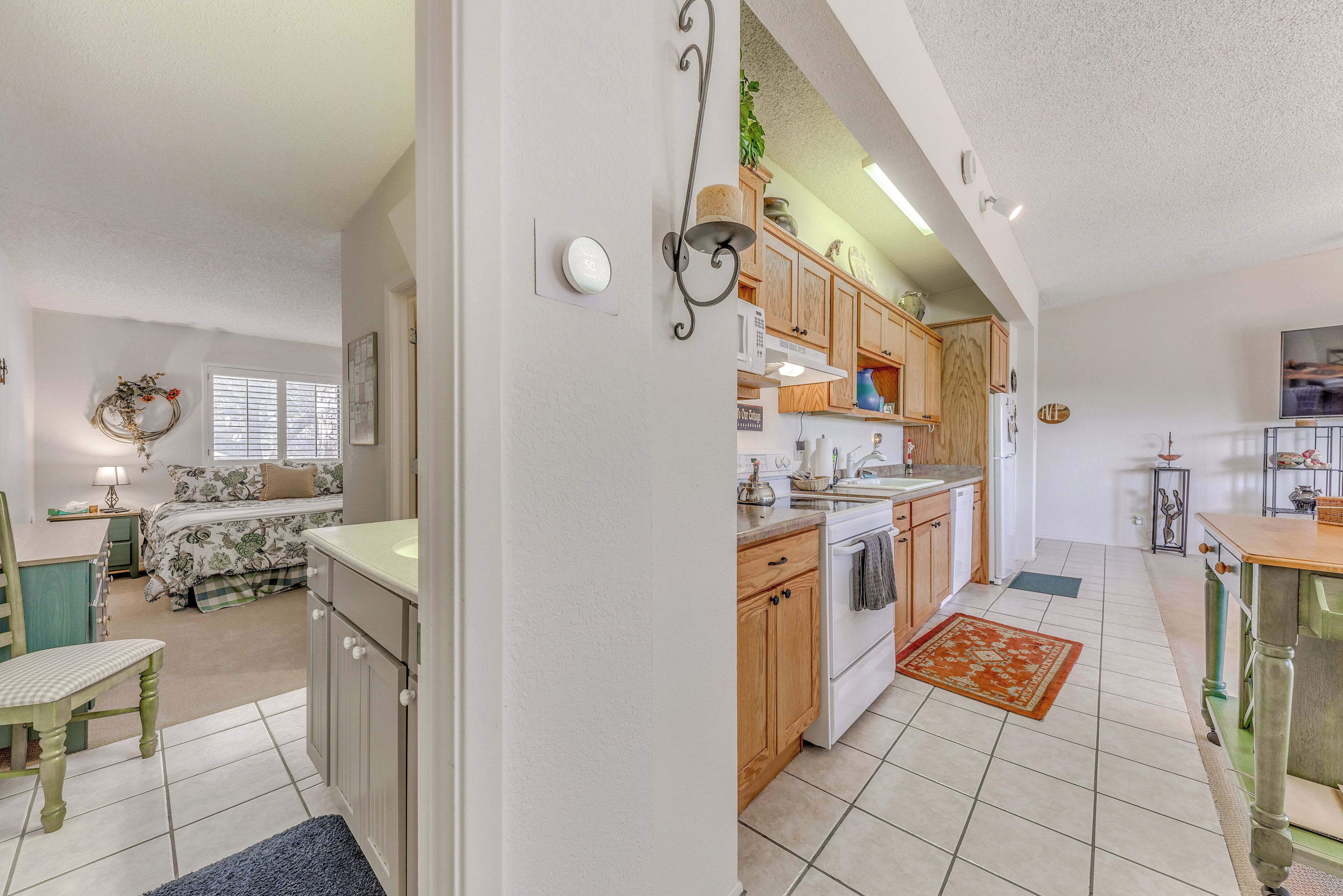 A spacious kitchen with wooden cabinets, a stove, and a dining area.