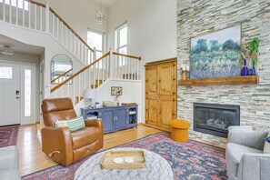 Relax in this inviting living area with a comfortable armchair, fireplace, and beautiful artwork.