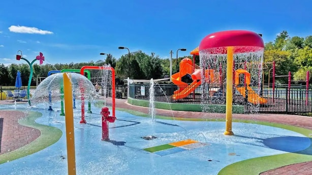 A water play area with multiple water jets and slides. - Villas at Seven Dwarfs 4BR, 3B, WiFi, 15min DW (Kissimmee)
