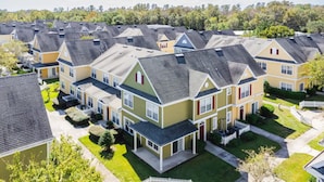 A residential area with multiple two-story houses, each with a sloped roof and a front porch. - Villas at Seven Dwarfs 4BR, 3B, WiFi, 15min DW (Kissimmee)