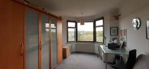 Enjoy a room with a corner desk, large window, and wardrobe.