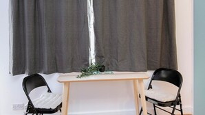 A room with a table and two chairs, a curtain, and a small plant on the table. - Studio With Parking, By Uni/Hosp (Exeter)