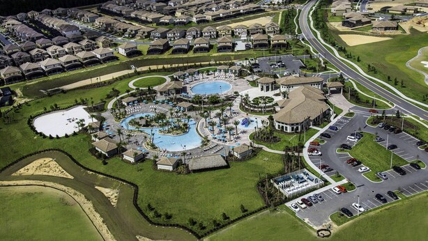 An aerial view of a resort with multiple swimming pools, a golf course, and a parking area. - Last Minute Disney! Private Pool, Hot Tub, Game Room & Themed Bedrooms. Book Now! #110995 (Orlando)